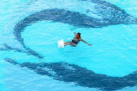 BANGKOK, THAILAND - MARCH 21 : Unidentified woman is swimming in swimming pool on March 21, 2013 at Prince Palace Hotel, Boe Bae Tower, Bangkok, Thailand.のeditorial素材