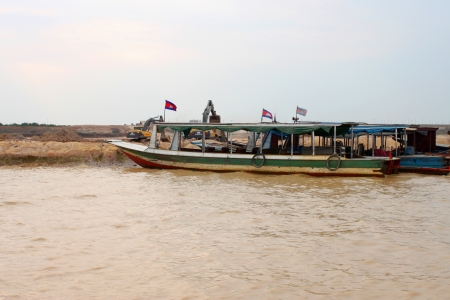 SIEMREAP, KHMER REPUBLIC - FEBRUARY 23 : Excavators are digging bank of the greatest freshwater lake in the world on February 23, 2013 at Tonle Sap Lake, Siemreap, Khmer Republic.のeditorial素材