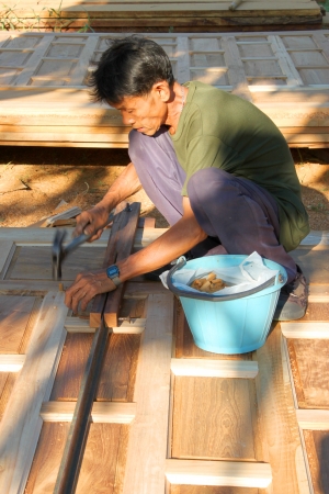 MAHASARAKHAM, THAILAND - APRIL 30 : Unidentified worker is working on building site on April 30, 2013 in Wang Nam Yen village, Muang, Mahasarakham, Thailand. This site is only for teakwood expert carpenters.のeditorial素材