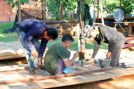 MAHASARAKHAM, THAILAND - APRIL 30 : Unidentified workers are working on building site on April 30, 2013 in Wang Nam Yen village, Muang, Mahasarakham, Thailand. This site is only for teakwood expert carpenters.のeditorial素材