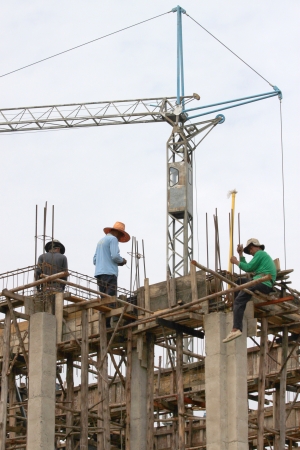 MAHASARAKHAM, THAILAND - MAY 22 : Unidentified workers are working on city hall building site on May 22, 2013 in Mahasarakham, Thailand.のeditorial素材