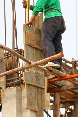 MAHASARAKHAM, THAILAND - MAY 22 : Unidentified workers are working on city hall building site on May 22, 2013 in Mahasarakham, Thailand.のeditorial素材