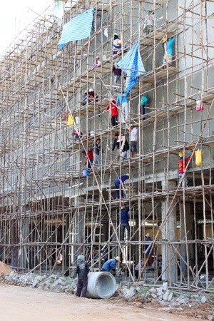BURIRAM, THAILAND - JUNE 29 : Unidentified workers are working on Taweekit Plaza construction building site on June 29, 2013 in Buriram, Thailand.のeditorial素材