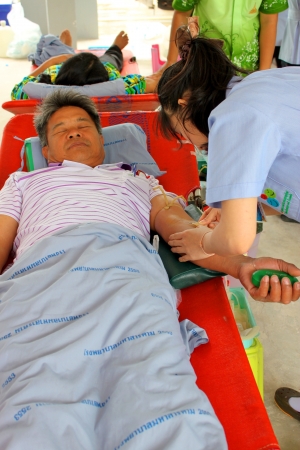 MAHASARAKHAM, THAILAND - AUGUST 21   Unidentified nurse is stabbing needle in manのeditorial素材