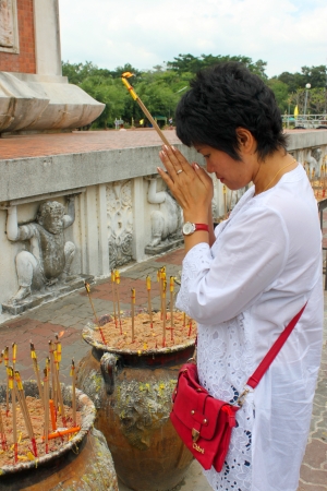 NA DUN, MAHASARAKHAM - OCTOBER 20   Unidentified woman is worshiping Buddha statue and making religious merit in end of Buddhist Lent festival at Na Dun pagoda  on October 20, 2013 in Mahasarakham, Thailand のeditorial素材