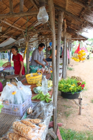 MAHASARAKHAM - AUGUST 6   Unidentified woman hawker is preparing take away foods and goods for sell at Tha Rae Wattana village market stall on August 6, 2013 in Mahasarakham, Thailand のeditorial素材