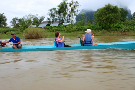 VANG VIENG, LAO P D R  - AUGUST 24   Unidentified tourists are on long-tailed boat tour in Song River on August 24, 2013 in Vang Vieng, Lao P D R のeditorial素材
