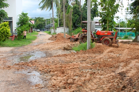 MAHASARAKHAM - JULY 25   Unidentified worker is riding tractor on building site at district hall on July 25, 2013 in Mahasarakham, Thailand のeditorial素材