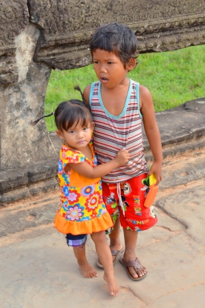 SIEM REAP, CAMBODIA - NOVEMBER 24   Unidentified Khmer children aged 3-4 years play at ancient temple and the most visited historic UNESCO World Heritage site, Angkor Wat on November 24, 2013 in Siem Reap, Cambodia  のeditorial素材