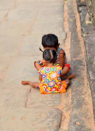 SIEM REAP, CAMBODIA - NOVEMBER 24   Unidentified Khmer children aged 3-4 years play at ancient temple and the most visited historic UNESCO World Heritage site, Angkor Wat on November 24, 2013 in Siem Reap, Cambodia のeditorial素材