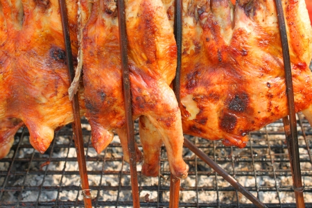 grilled chicken over gridiron and low heat from natural charcoalの写真素材