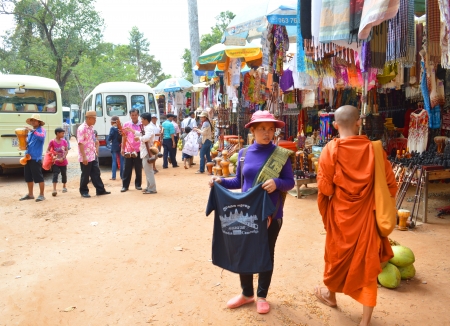 SIEM REAP, CAMBODIA - NOVEMBER 24   Unidentified woman sells clothes at entrance of ancient architecture of The Ta Prohm in Angkor Thom on November 24, 2013 in Siem Reap, Cambodia のeditorial素材