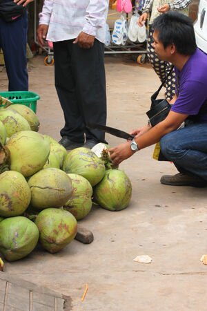 KA LAN, CAMBODIA - NOVEMBER 23   Unidentified man is selling coconuts at local market on November 23, 2013 in Ka Lan, Cambodia のeditorial素材