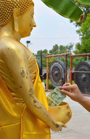money donation for Buddhist religious merit の写真素材