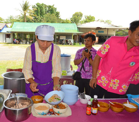 MAHASARAKHAM - JULY 7   Woman chef is preparing food at Khwao Subdistrict Administrative Organization market on July 7, 2014 in Mahasarakham, Thailand のeditorial素材