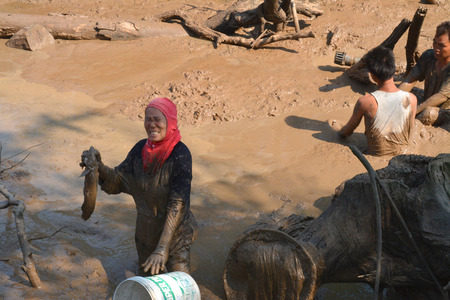 YANGSRISURAT - APRIL 4 : Villagers catch fishes in shallow pond in the dry season on April 4, 2015...