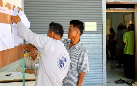 PAYAKKAPHUMPHISAI  JUNE  28 : Villagers check name list to vote for representative of farmer's reconstruction and development fund on June 28 2015 in Payakkaphumphisai Mahasarakham Thailand.のeditorial素材