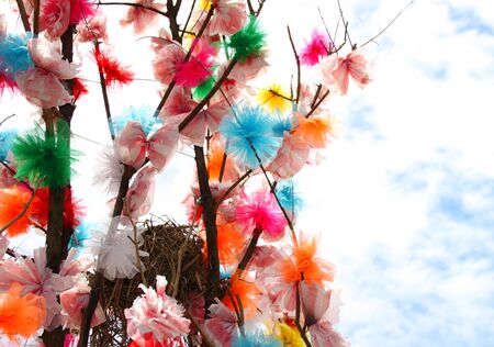 bird nest and blossom flowers on tree made from clothes