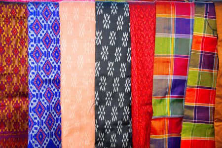 local Thai silk clothes background in market stallの写真素材