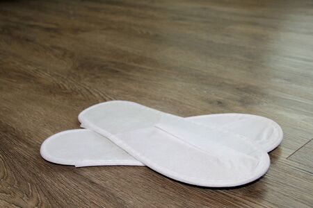 white sandals on wooden floor in the morning light roomの写真素材