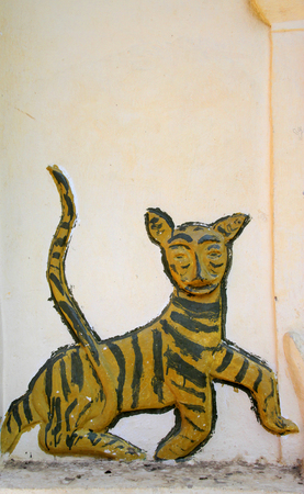 MAHASARAKHAM - DECEMBER 30 : Founded in 1924, old tiger stucco on temple wall of Wat Ban Chiang Hean traditional Northeast style on December 30, 2014 in Muang, Mahasarakham, Thailand.のeditorial素材