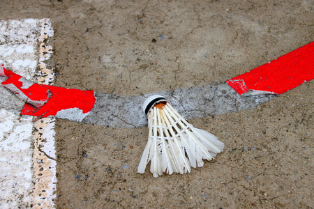old shuttlecock on dirty concrete court sport groundの写真素材