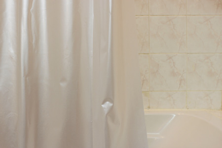 plastic curtain in bathroom interior in low light colorの写真素材