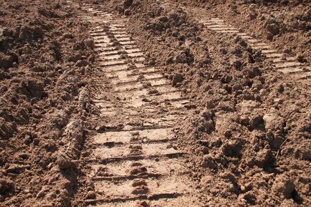 tractor track on sandy soil at road construction siteの写真素材
