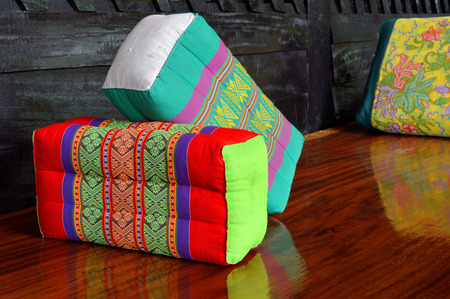 Thai handmade cotton pillow decorated on the table in lobby roomの写真素材