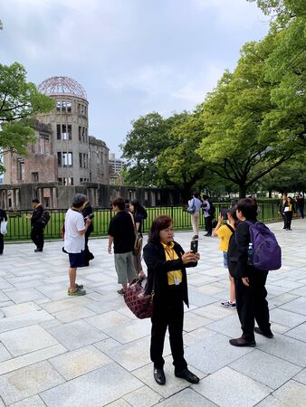 Hiroshima, Japan - August 21, 2019: Tourists visit Atomic Bomb Dome or Genbaku Dome on August 21, 2019 in Hiroshima, Japan.のeditorial素材