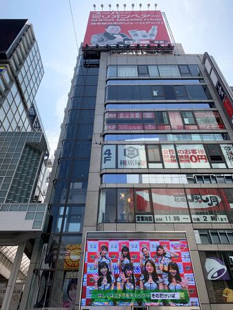 OSAKA, JAPAN - AUGUST 24, 2019 : High buildings are located at Dotonbori street the famous large market and metropolitan area on August 24, 2019 in Osaka, Japan.のeditorial素材