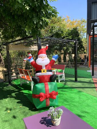 NAKHON RATCHASIMA, THAILAND - DECEMBER 15, 2019 : Santa Claus puppet is displayed in front of food shop on December 15, 2019 in Nakhon Ratchasima, Thailand.のeditorial素材