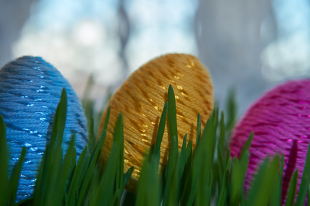 Easter Craft Ideas. The Easter egg decorated with multicolored paper,  placed between frech green wheat germs.の写真素材