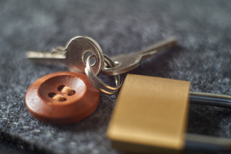 Brass lock, keys playing with light, shadow, reflection and surfaces, selective focusの写真素材