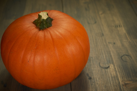 Orange Halloween pumpkin on old rustic wood table with free copy spaceの写真素材