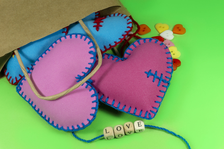 Paper bag full of handmade heart souvenirs and Love letters on green chromakey background. Valentine Day conceptの写真素材