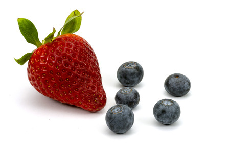 Strawberry and blueberries isolated on white and viewed in close-upの写真素材