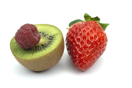 Assortment of fresh fruits including kiwi strawberry raspberry on white backgroundの写真素材