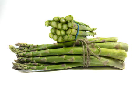 Two bundles of fresh green asparagus isolated on white background, keep asparagus fresh conceptの写真素材