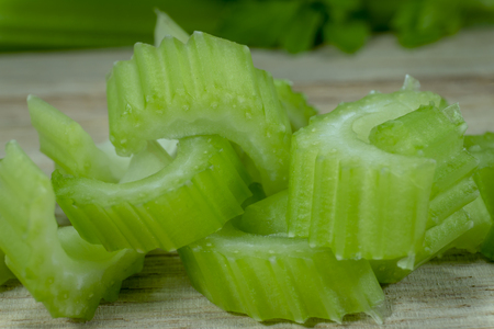 Sliced fresh celery on a cutting wooden board. Healthy eating, vegetarian food, diet, dieting conceptの写真素材