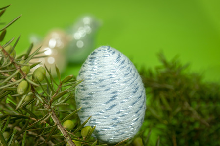 Happy Easter symbol egg on green background with space for copy, text or words. Easter decor, selective focus.の写真素材