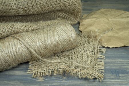 Spools of burlap threads or jute twine, sackcloth fabric in close-up on rustic grey backgroundの写真素材