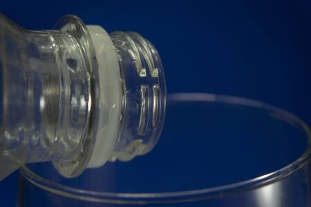 Close up of transparent white used plastic water bottle neck, recycling and food storage conceptの写真素材