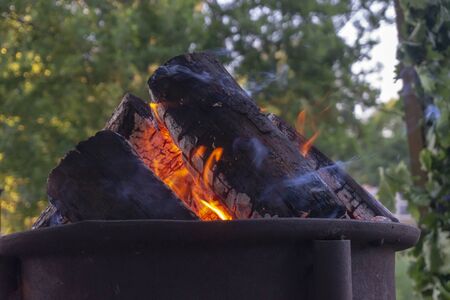 Low angle ground level view of a blazing camp fire with orange flamesの写真素材