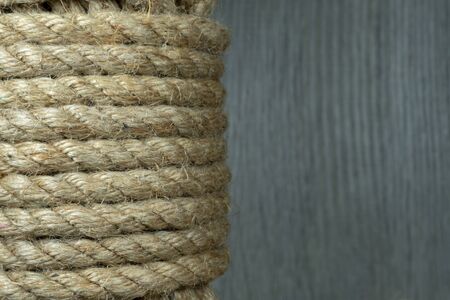 Twisted burlap jute twine rope in close-up on grey rustic backgroundの写真素材