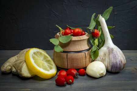Natural remedies for cold and flu season with fresh root ginger, lemon, garlic and rose hipsの写真素材