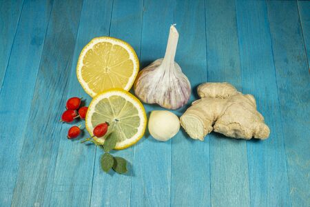Natural remedies for cold and flu season with fresh root ginger, lemon, garlic and rose hipsの写真素材