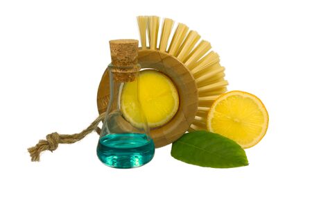 Slices of lemon, flask and dish brushes isolated on white background, concept of the alternative uses for lemonsの写真素材