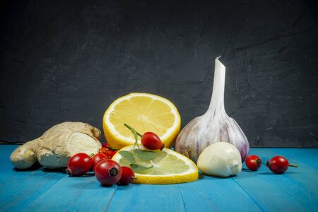 Natural remedies for cold and flu season with fresh root ginger, lemon, garlic and rose hipsの写真素材