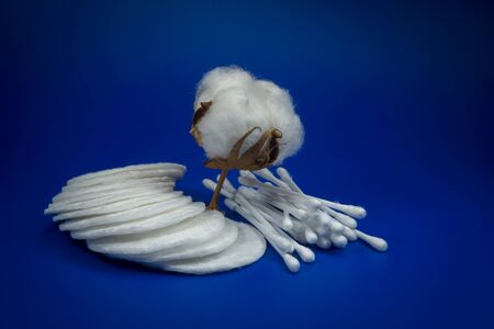 Cotton boll showing the cotton in the raw as picked from the plant with ear buds and facial pads in a concept of production of natural resourcesの写真素材